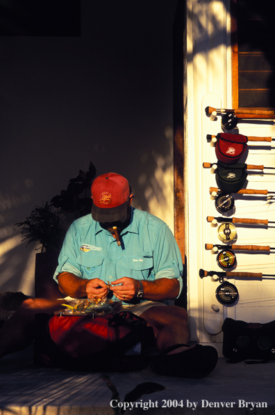 Saltwater flyfisherman checking gear.