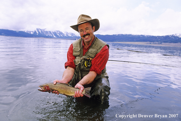 Flyfisherman with large cutthroat trout.