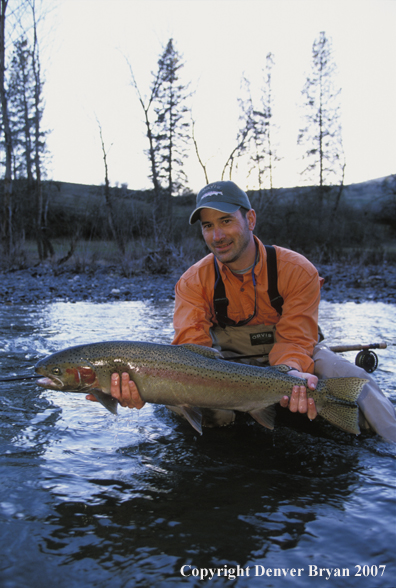 Flyfisherman holding steelhead.