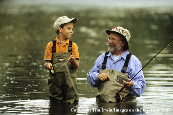 Grandfather teaching grandson how to fish