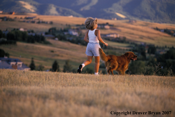 Woman running with golden Retriever