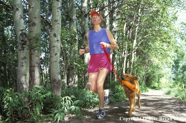 Woman running with golden Retriever