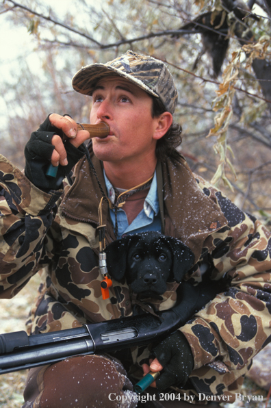 Waterfowl hunter calling birds.