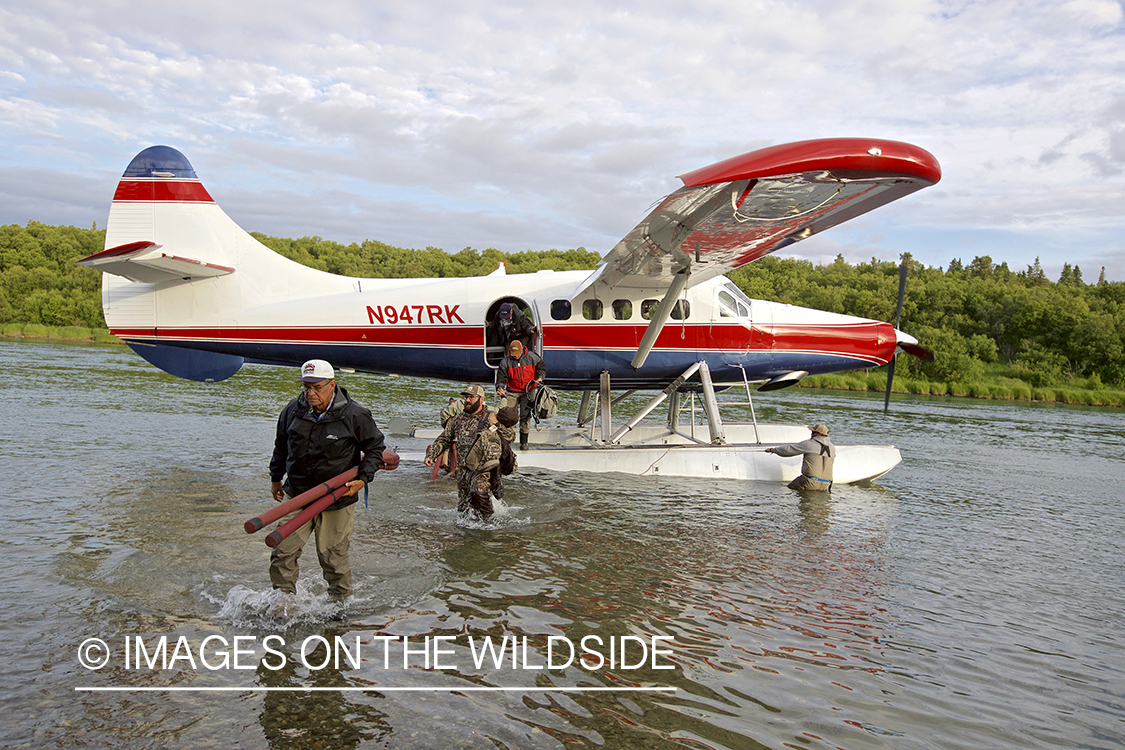 Flyfishermen unloading float plane.