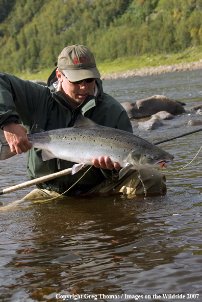 Flyfisherman showing off a nice Atlantic Salmon