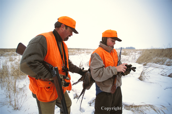 Father and son pheasant hunting.