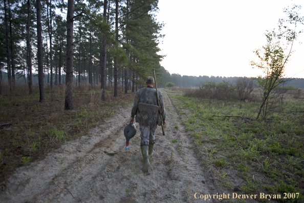 Turkey hunter in field with bagged bird