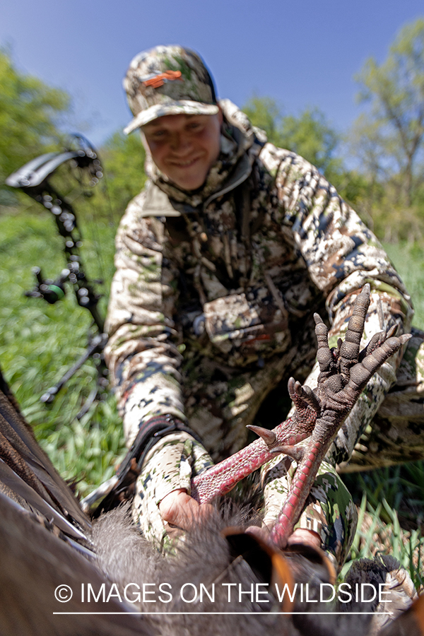 Turkey hunter with bagged turkey.