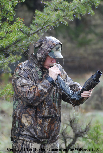 Bowhunter bugling for elk