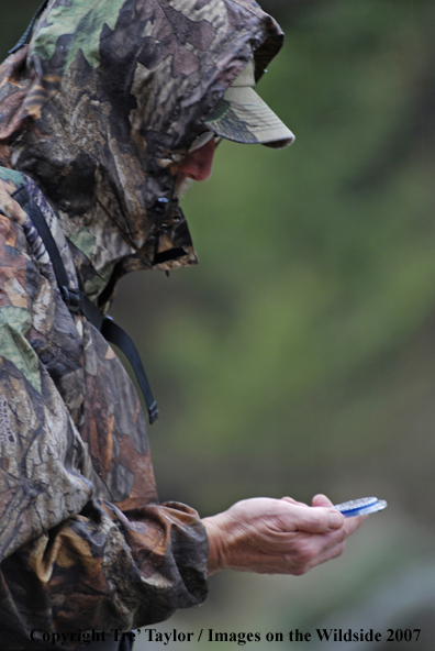 Bowhunter looking at compass