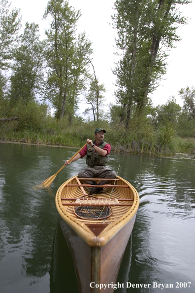 Man canoeing on pond (MR).