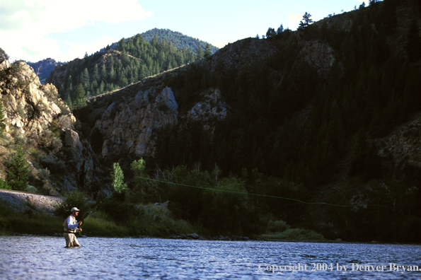 Flyfisherman casting on river.