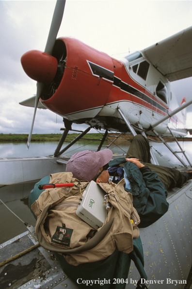 Flyfisherman sleeping on float plane.