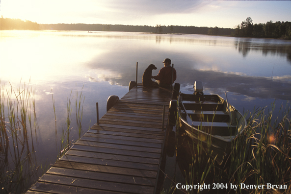 Spincast fisherman with dog.