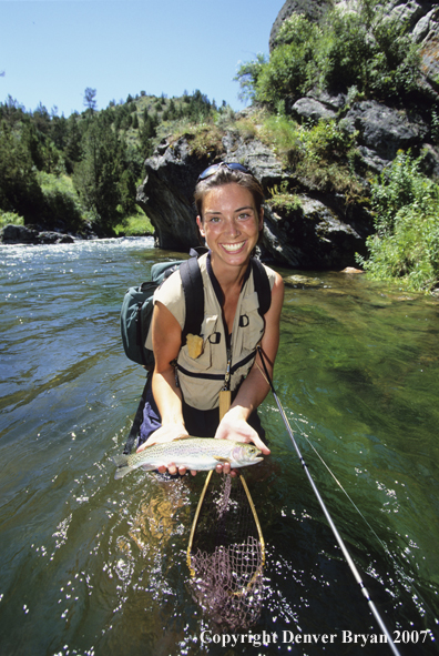 Female flyfisher with rainbow.