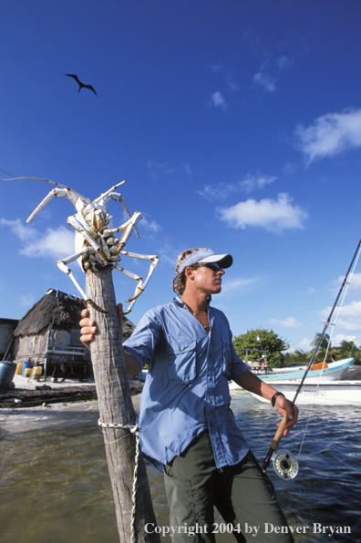 Saltwater flyfisherman checking conditions from shore.