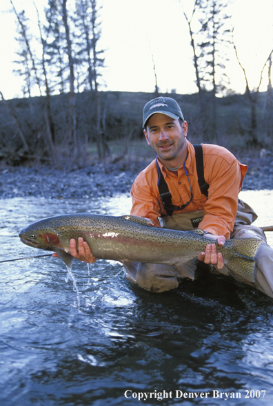 Flyfisherman holding steelhead.