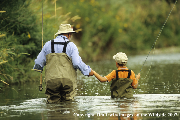 Grandfather teaching grandson how to fish