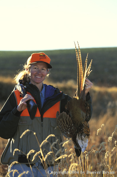 Upland game bird hunter with bagged pheasant.