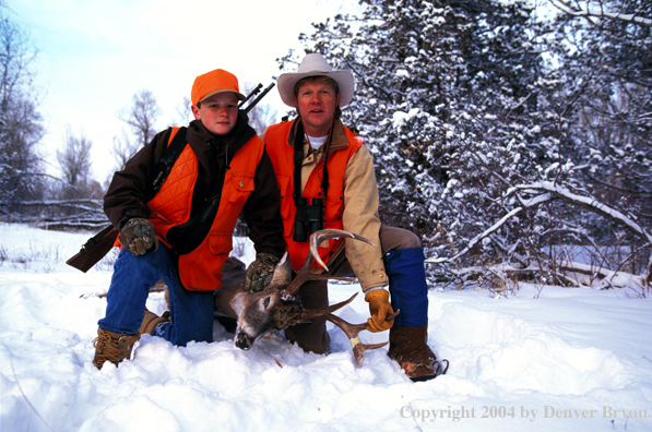 Father and son with white-tailed deer.