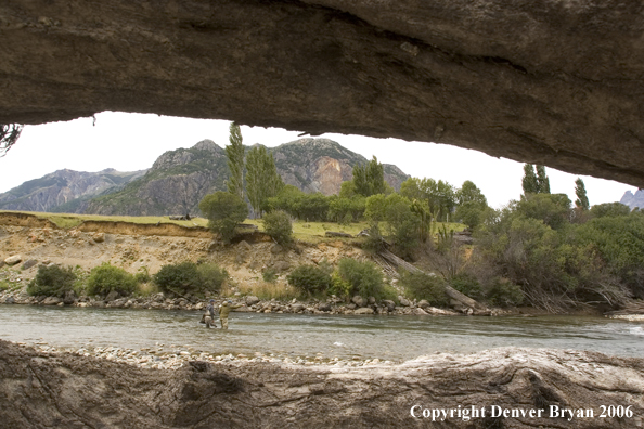 Flyfishermen looking up river.