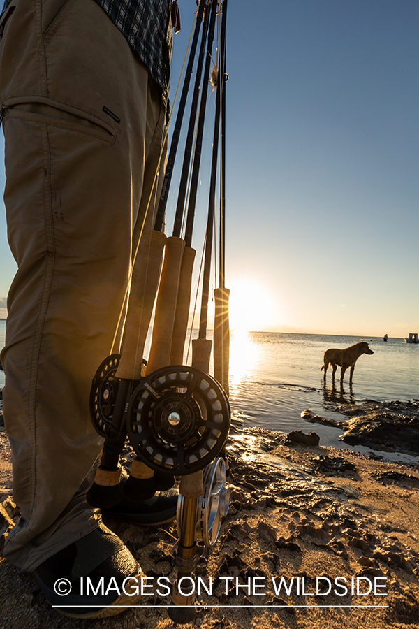 Flyfisherman on beach with fly rods.