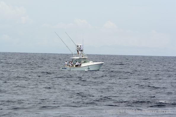 Deep sea fishing charter boat on ocean.