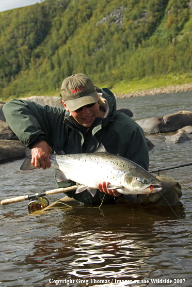 Flyfisherman showing off a nice Atlantic Salmon