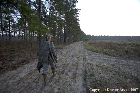 Turkey hunter in field with bagged turkey