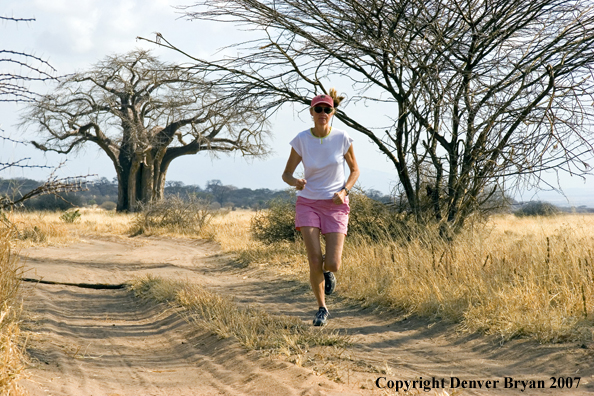 Woman jogging in Tarangire National Park, Tanzania, Africa