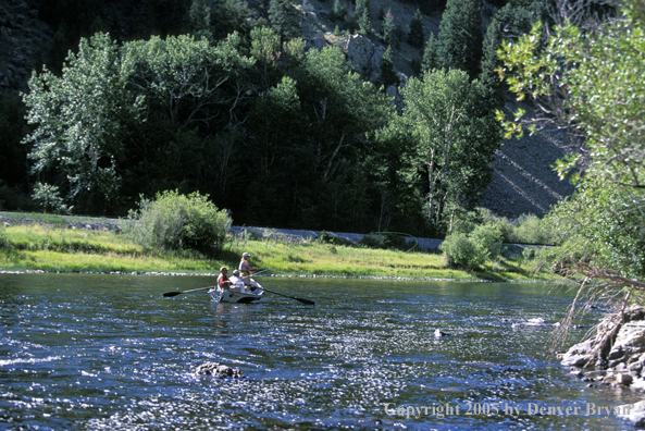 Fly fisherman fishing from driftboat.