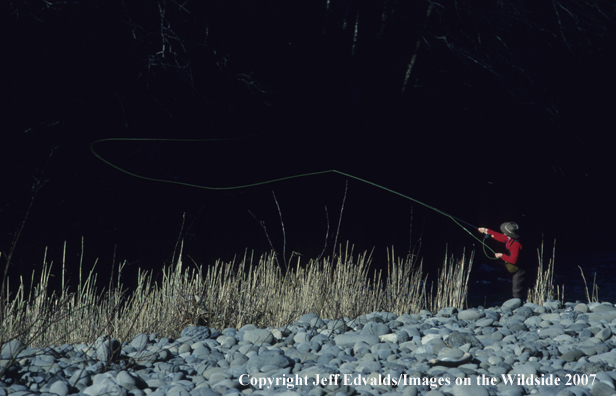 Angler casts in the early morning light