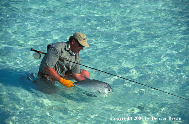 Saltwater flyfisherman holding trevally.