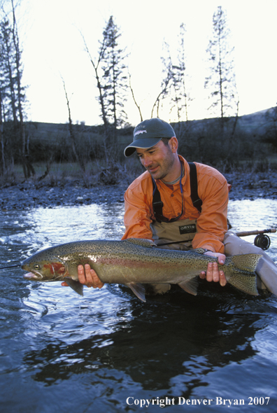 Flyfisherman holding steelhead.