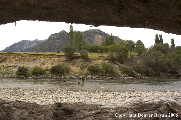 Flyfishermen walking up river.