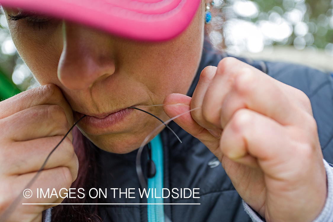 Camille Egdorf tying on fly at fishing camp.