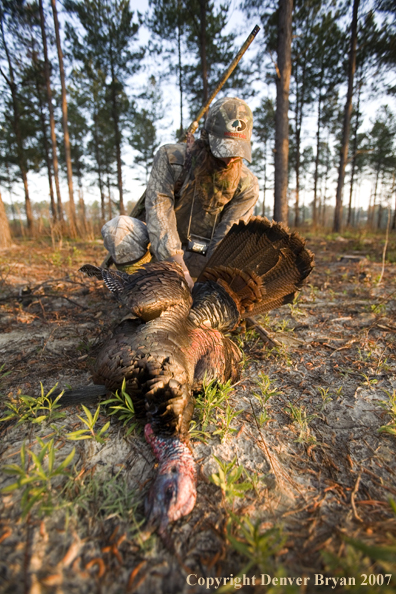 Turkey hunter in field with bagged bird