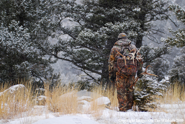 Hunter Collecting Antlers