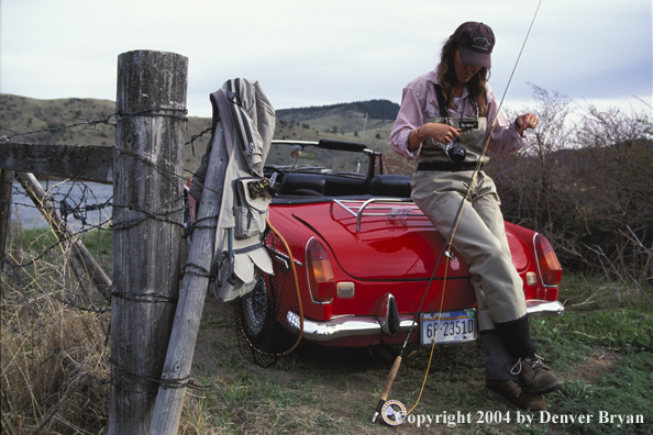 Woman flyfisher tying flies.