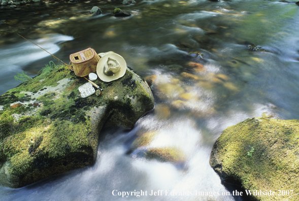 Still-life of old fishing gear in middle of stream.