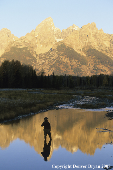 Angler fishing at sunset