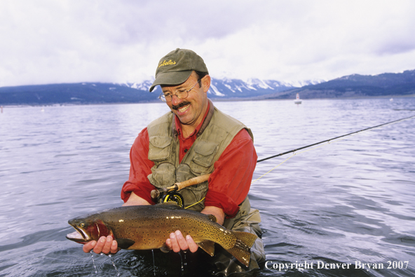 Flyfisherman with large cutthroat trout.