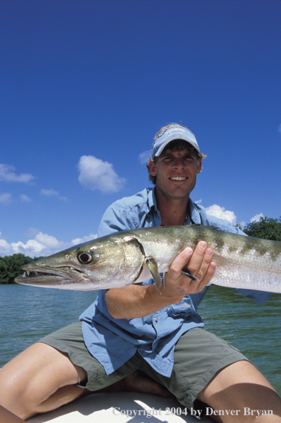 Saltwater flyfisherman on deck with barricuda.