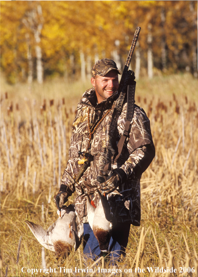 Waterfowl hunter with bagged ducks.