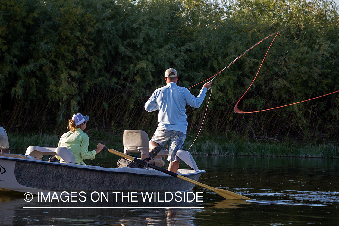 Flyfisherman casting from drift boat.