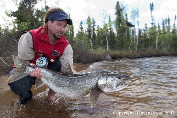 Flyfisherman with lake trout (MR).