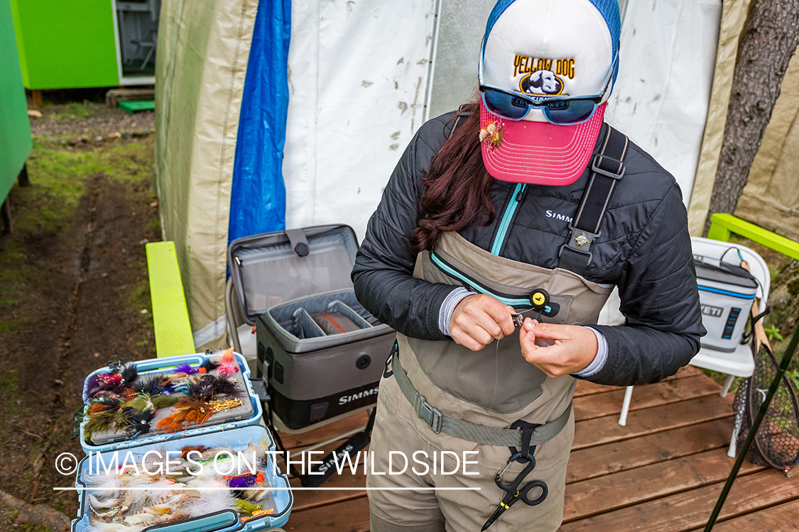 Camille Egdorf tying on fly at fishing camp.