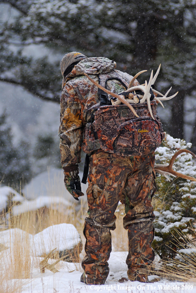 Hunter Collecting Antlers