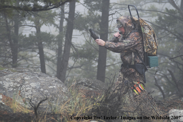 Bowhunter bugling for elk