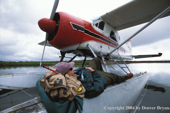 Flyfisherman sleeping on float plane.